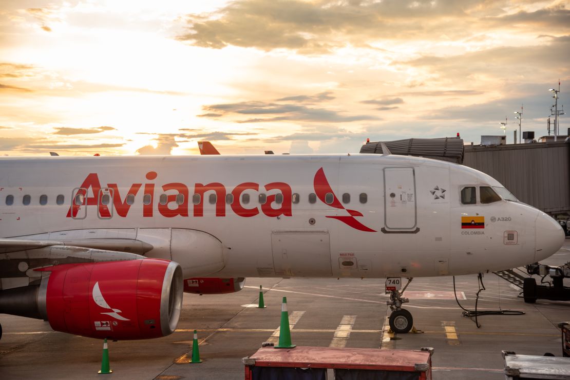 A photo of the side of an Avianca Airbus jet parked at the gate in Bogota