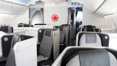 An Air Canada long-haul business class cabin with lie-flat seats.