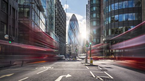 Buses on the street in the London financial district. 