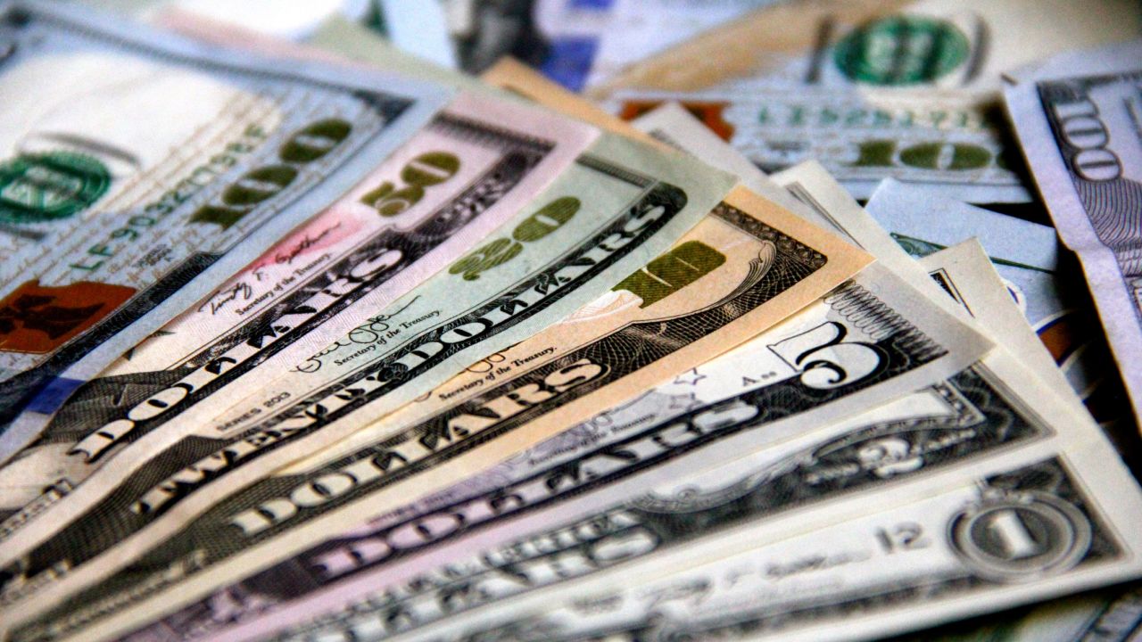 A photo of various US dollar bills in different denominations