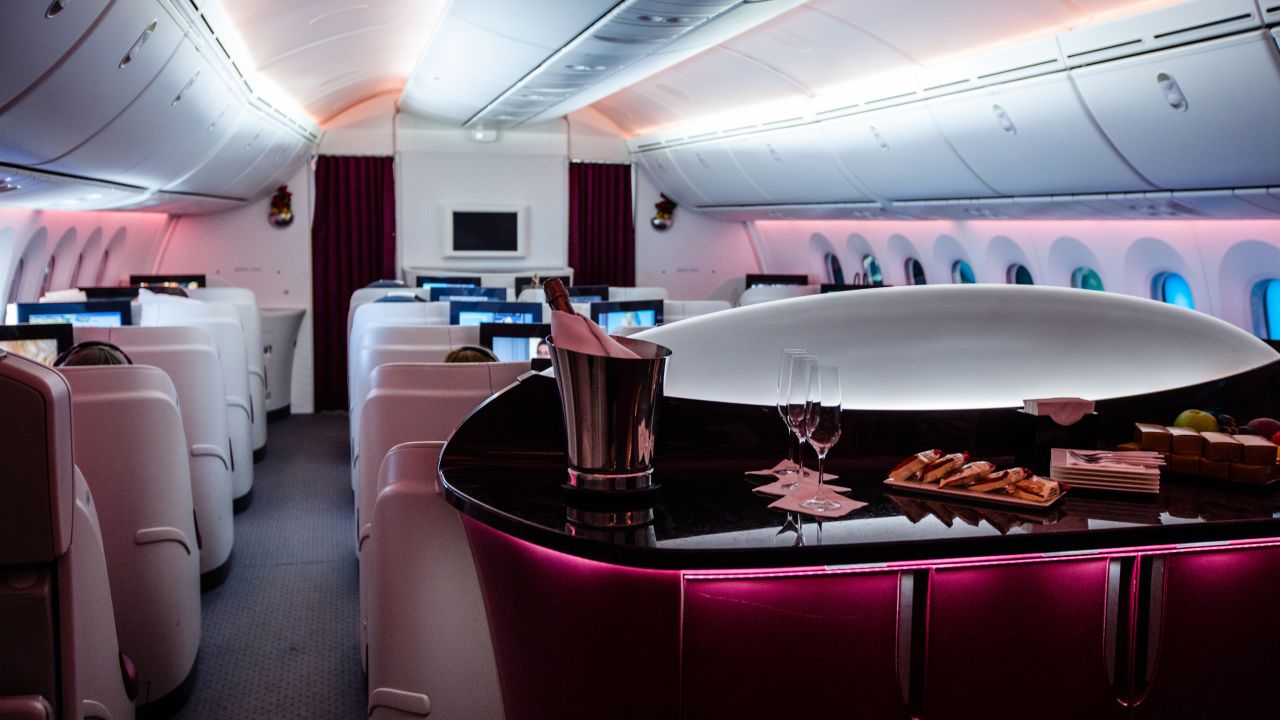 A photo of a Qatar Airways business class cabin on an airplane