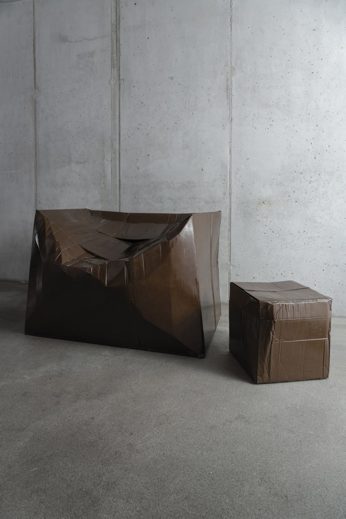 Illya Goldman Gubin strengthens misshapen cardboard boxes using resin and fiberglass.