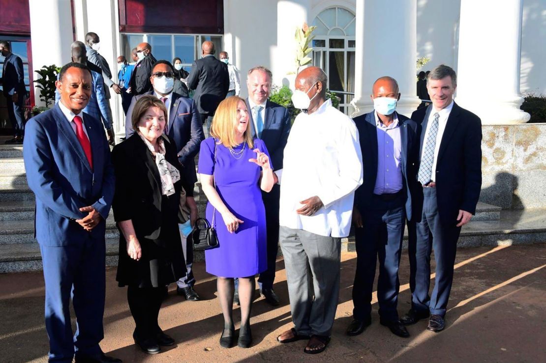 Family Watch International founder Sharon Slater (in purple) is pictured with Ugandan President Yoweri Museveni (wearing a face mask) outside Uganda's State House in April during a conference on so-called "family values."
