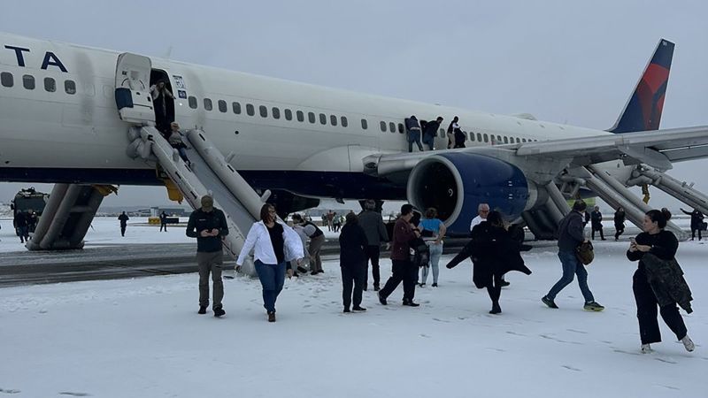 Passengers evacuate Delta flight on slides after engine trouble