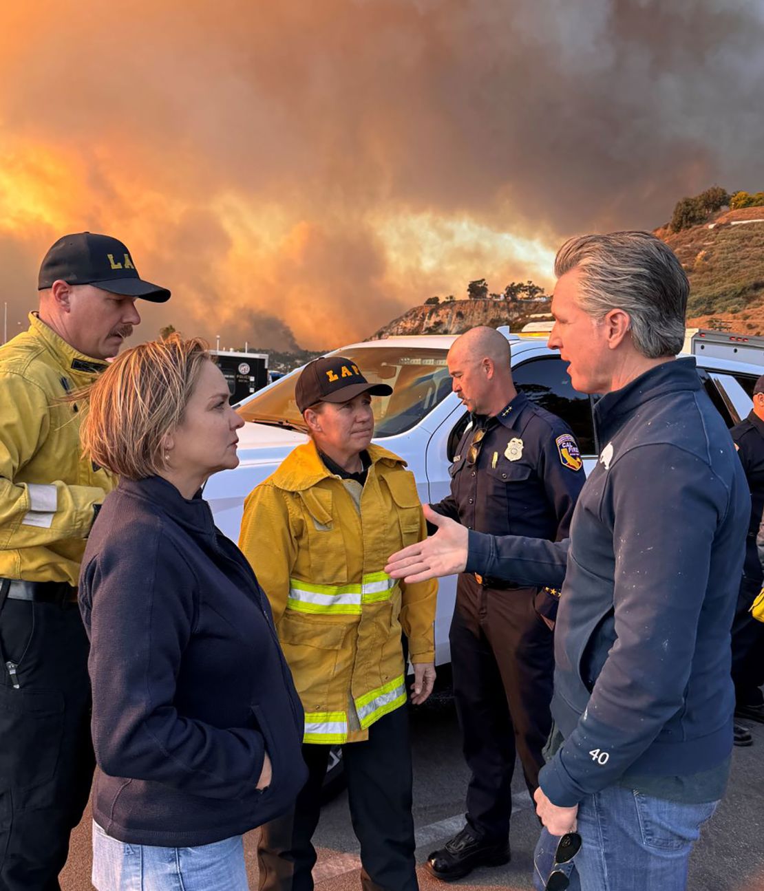 Los Angeles City Council Member Traci Parks speaks with Los Angeles Fire Chief Kristin Crowley and California Governor Gavin Newsom.