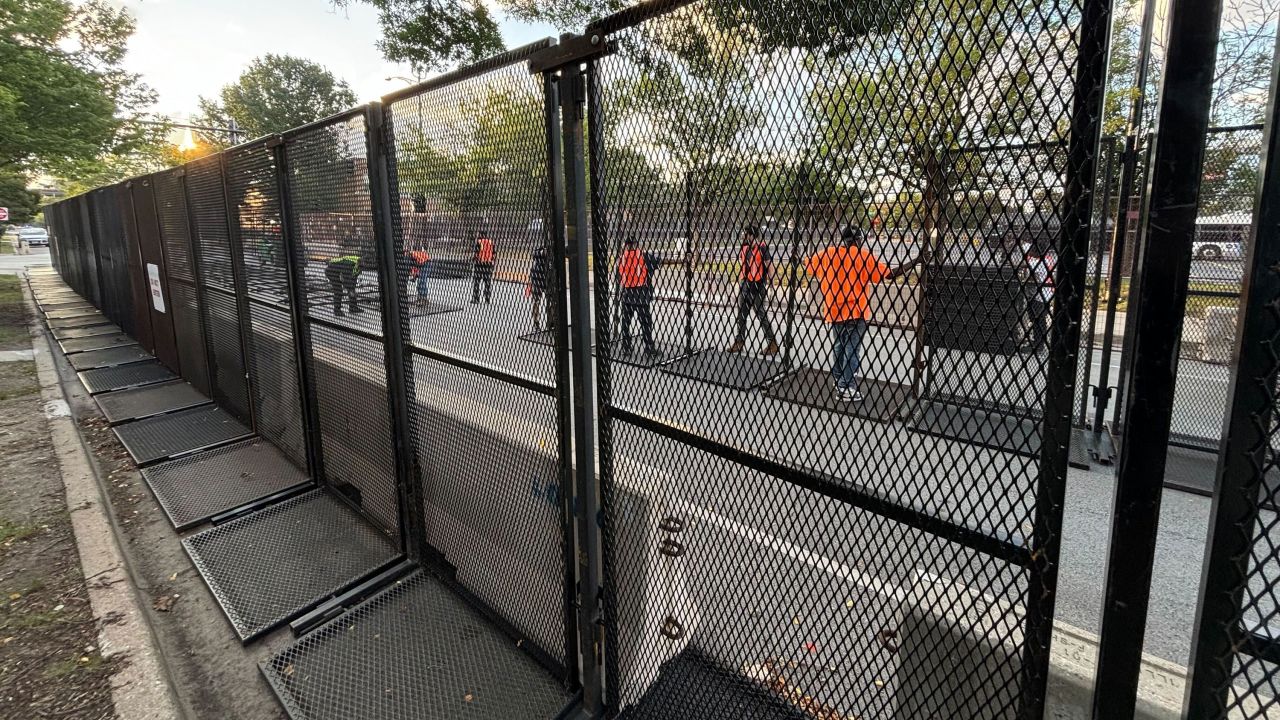 Chicago workers set up the additional line of security fences outside the United Center on Tuesday morning.