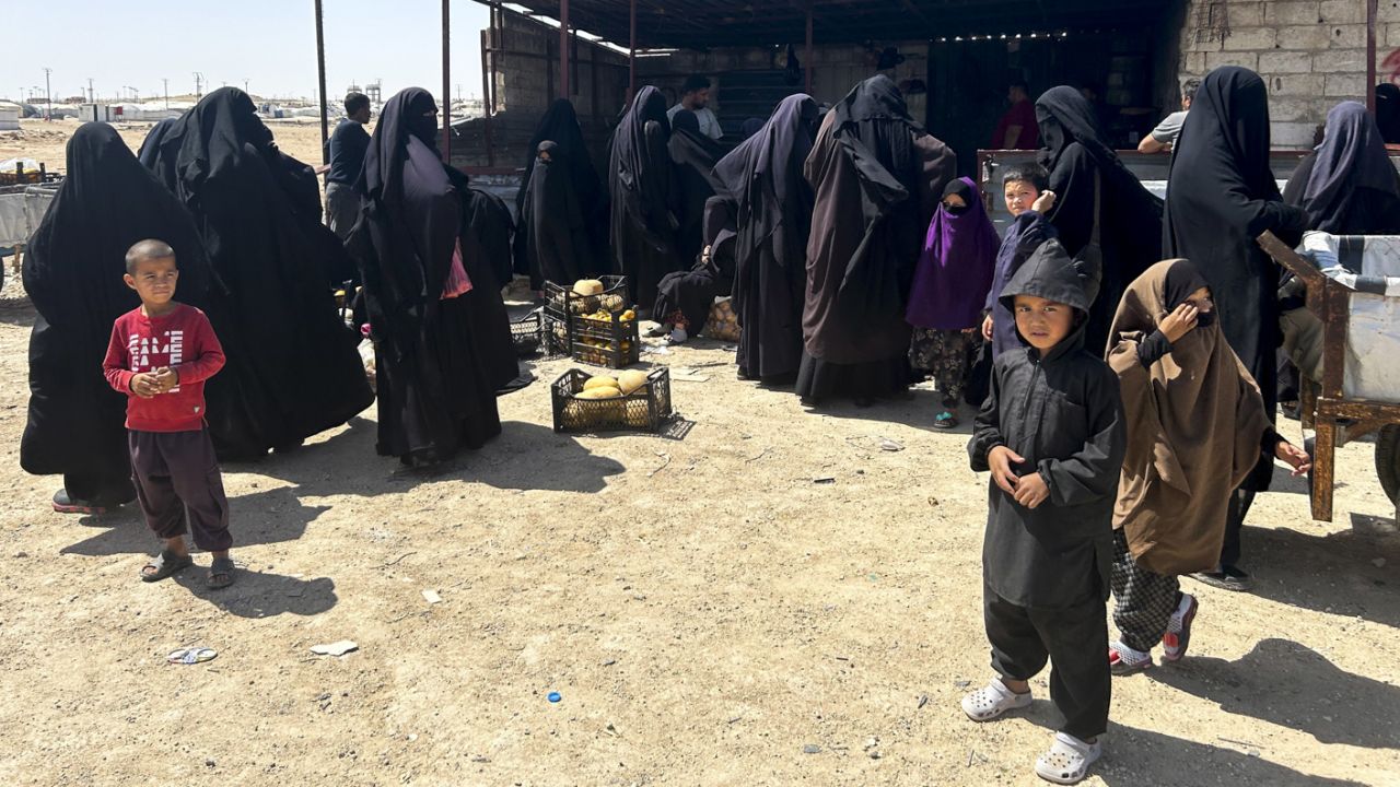 Women and children gather at a small market at the entry point to Al-Hol, a detention camp for suspected ISIS fighters and their family members in northeast Syria.