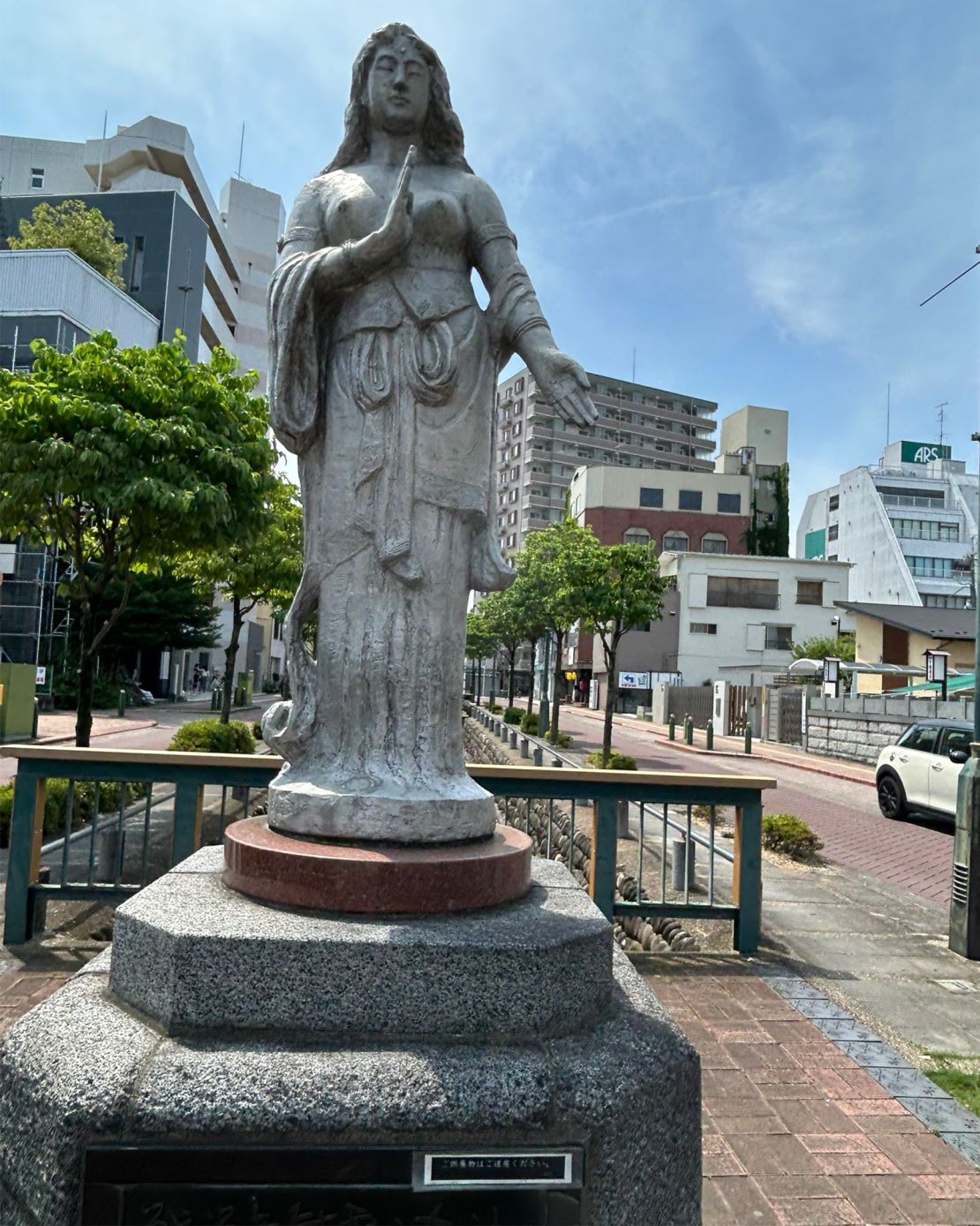 A statue to the victims of the 1945 bombing of Kumagaya sits by a stream, near a spot where dozens died from the US air attack.