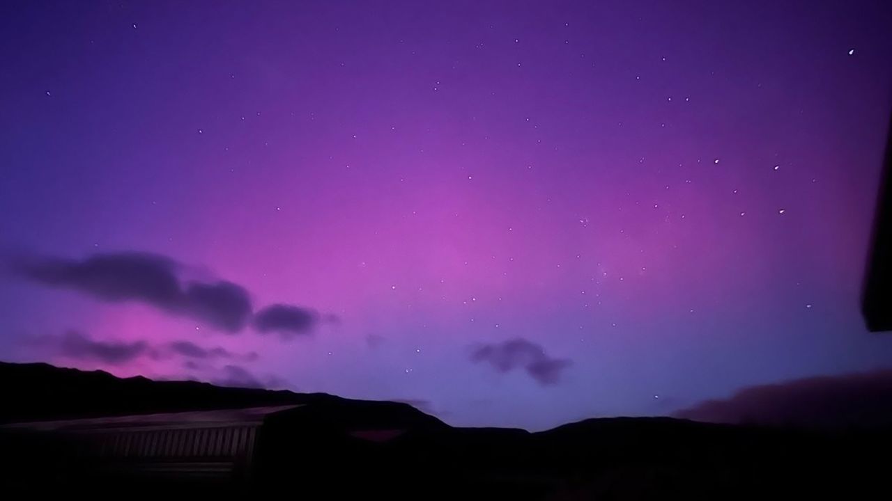 Andrew Dickson had one of the best seats to view the southern lights – his very own front yard in Central Otago, South Island of New Zealand , he told CNN.<br /><br /><br />Dickson, an early riser routinely, knew to expect an aurora but didn’t expect the view he saw, he said.<br /><br /><br />His family is building a bigger home and living in two smaller ones temporarily. While walking across the deck to grab something from one of the homes he looked up and said he knew he had to get some photos.<br /><br /><br />“I live rurally so virtually no light pollution” could hinder his chance at grabbing the photos he took with his iPhone 13 plus with a 3 second exposure, he said.