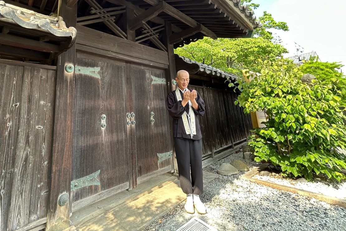 Tetsuya Okayasu, head priest of the Sekijoji Buddhist temple in Kumagaya, Japan, shows a gate roof under which he and six other members of his family lived for six months following the US firebombing of Kumagaya, Japan, on the last night of World War II.