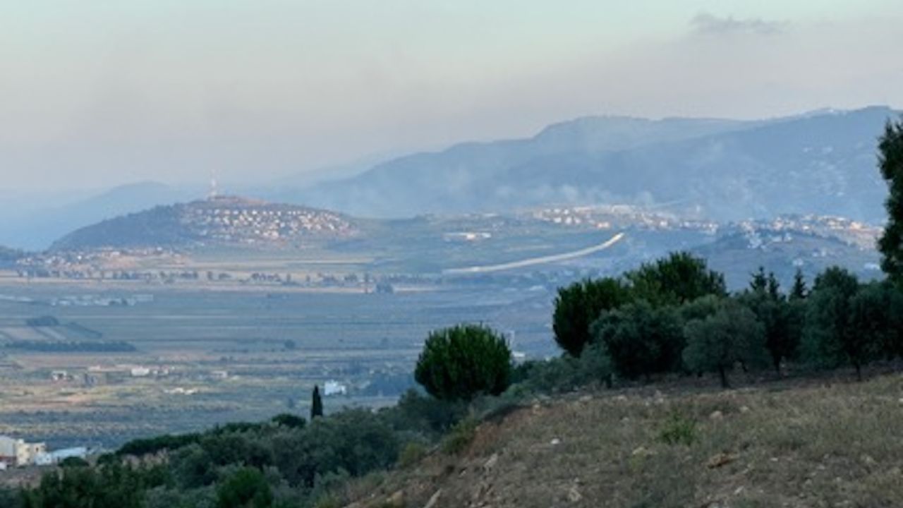 The town of Metula, Israel as seen from southern Lebanon. Smoke rises on the Lebanese side of the partition after an Israeli strike.
