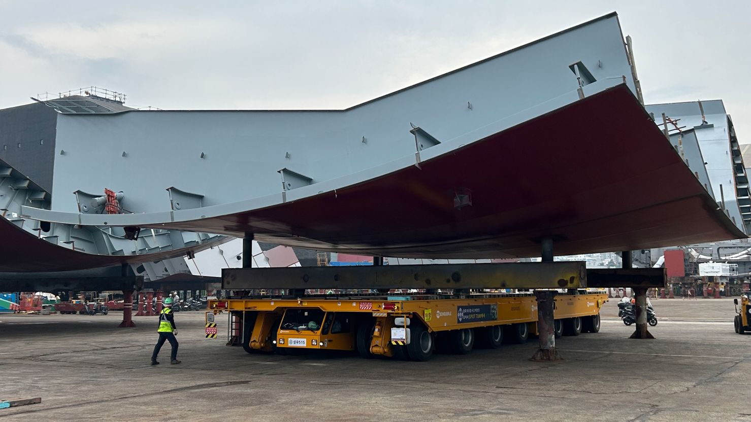 A section of ship hull is placed on four stanchions during the assembly process at HD Hyundai Heavy Industries shipyard in Ulsan, South Korea.
