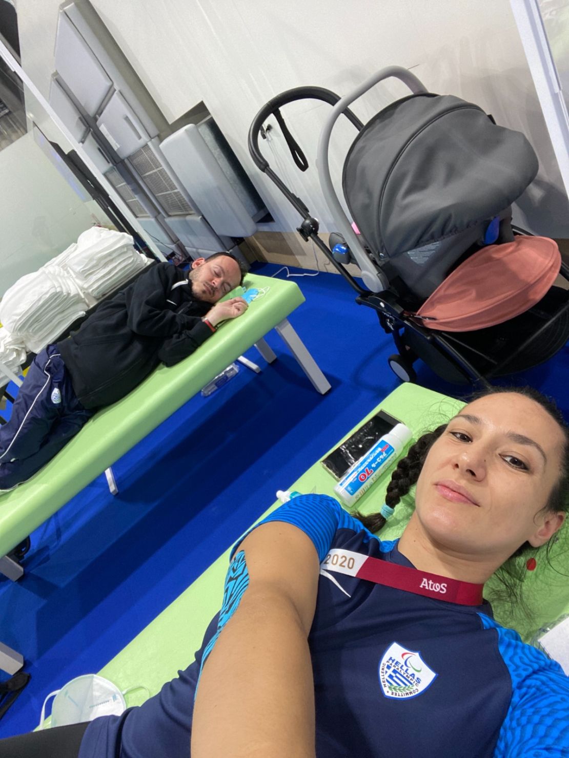 Greek boccia Paralympian Greg Polychronidis, along with his sports assistant and wife Katarina Polychronidis Patroni, rest with their baby after winning a silver medal in boccia representing Greece at the Tokyo 2020 Paralympic Games in 2021.