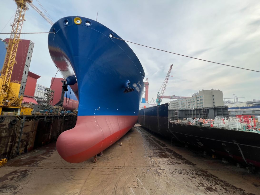 A ship under construction is in a drydock at HD Hyundai Heavy Industries in Ulsan, South Korea. A portion of this image was blurred by CNN to comply with media restrictions at the shipyard.