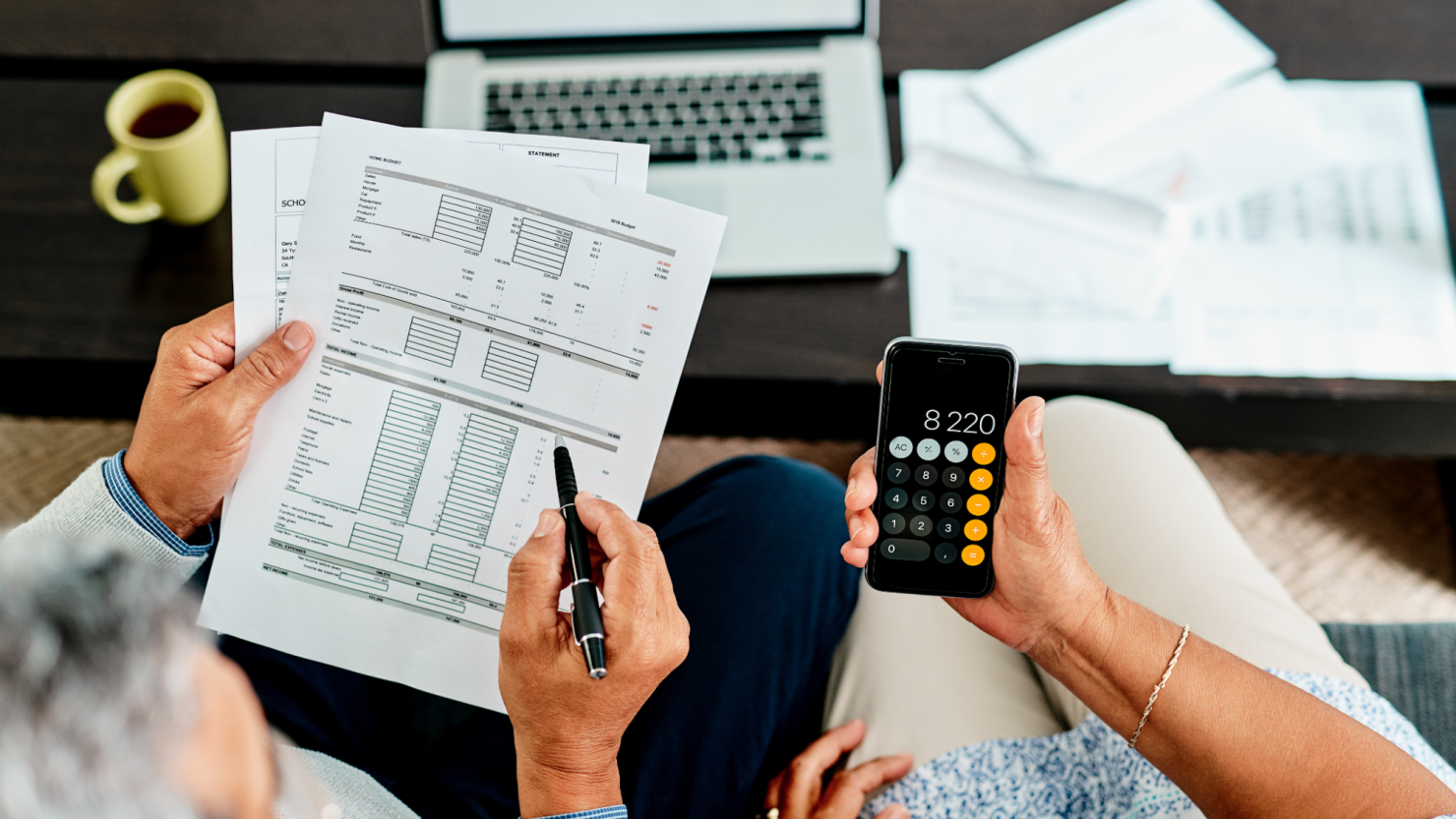 Couple calculating their finances together at home