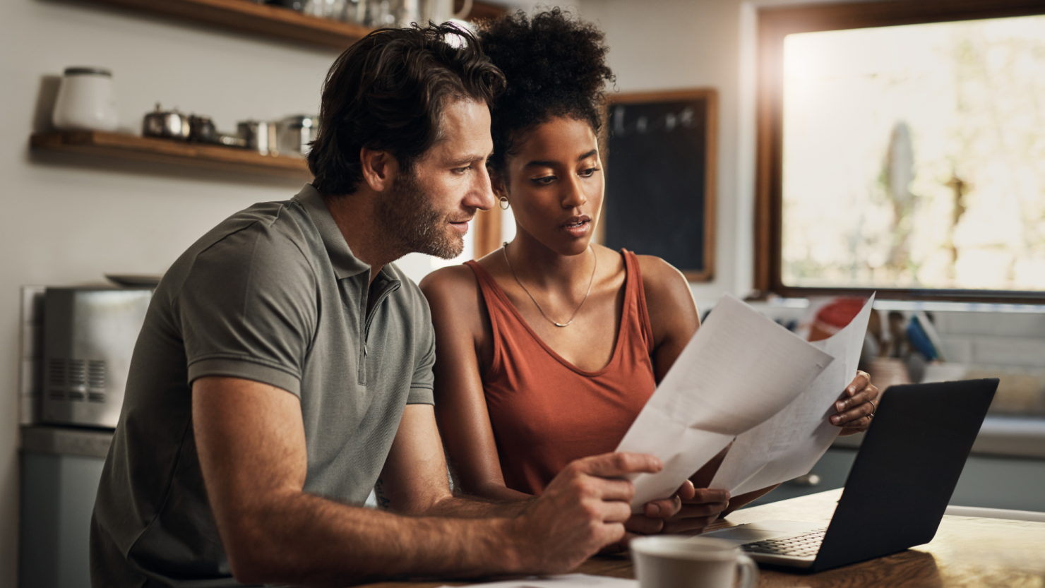 Concerned couple reviews paperwork