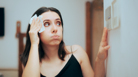 Woman adjusts AC temperature settings