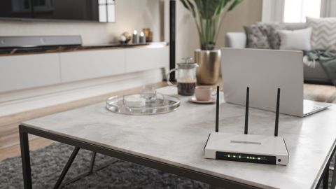 An internet router and laptop on a coffee table