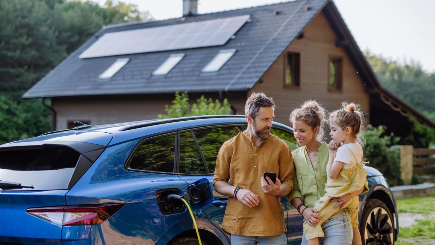 Family looking at how much energy their solar panels are producing.