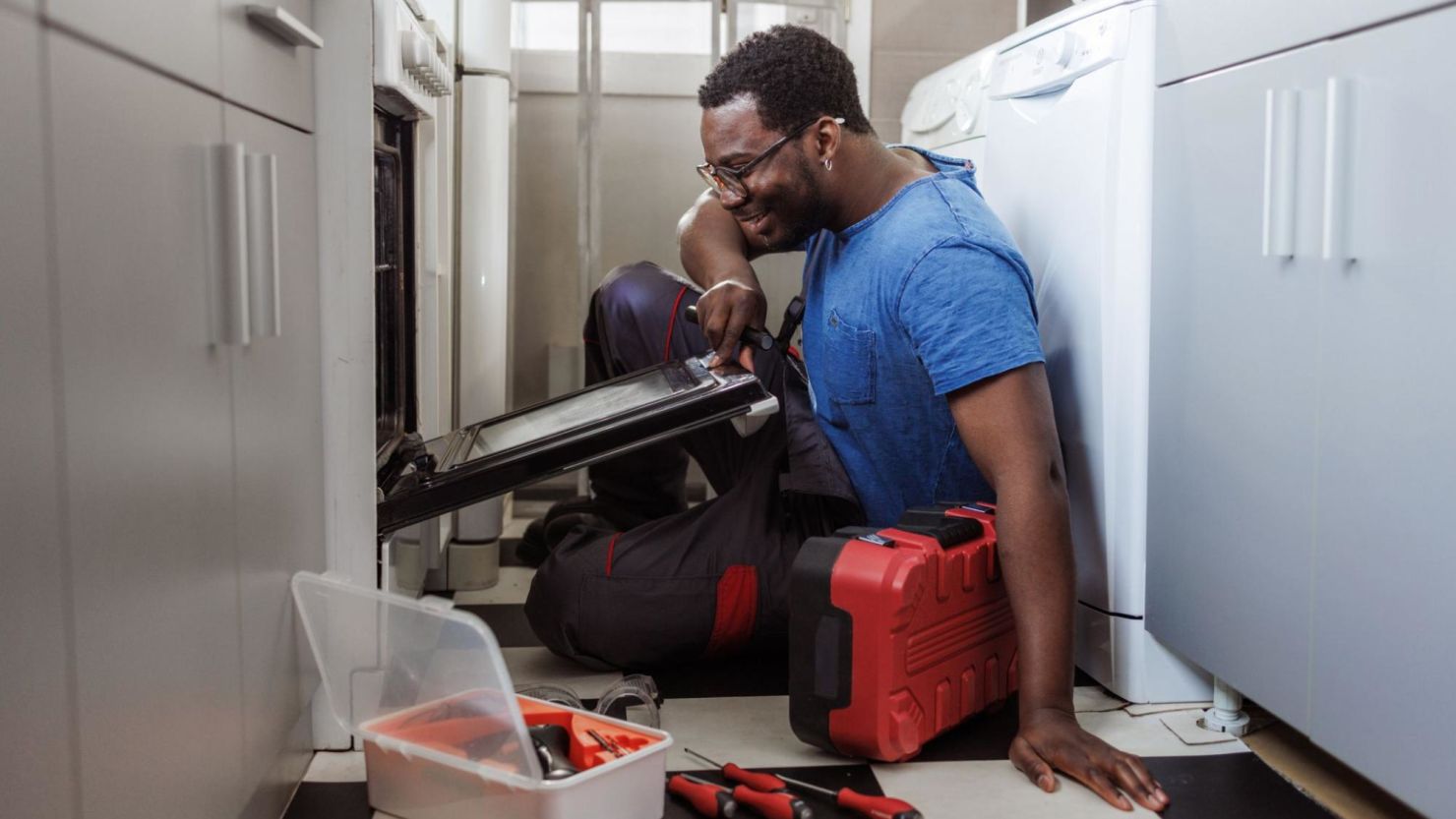 Service technician fixing an oven.