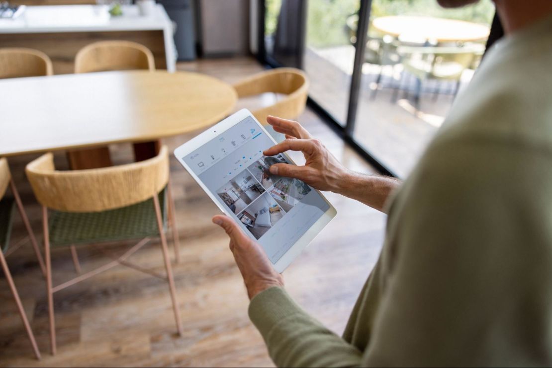 Homeowner checking their home security cameras