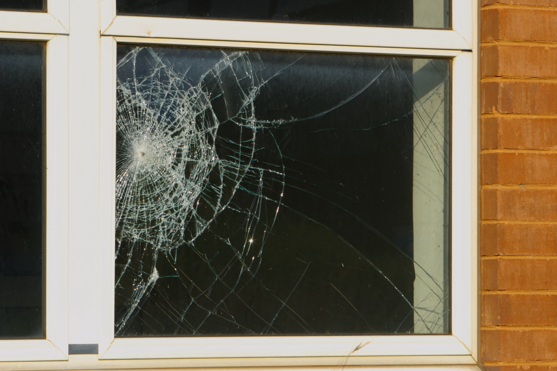 A broken window with shatter-proof glass