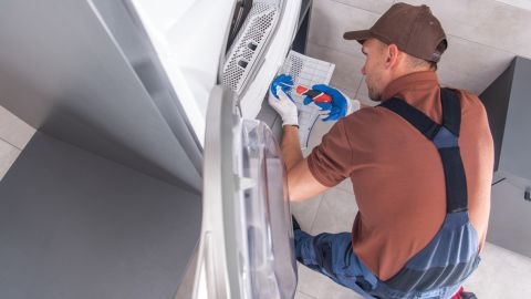 Technician fixing a dryer