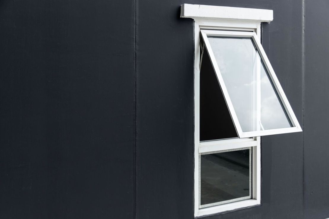 White awning window on a black house