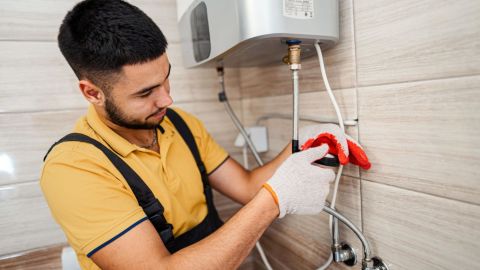 Service technician fixing water lines.