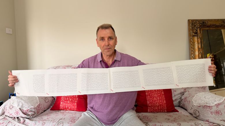 Laurence Watkins, a retired security guard from Auckland, New Zealand, holds his six-page birth certificate which lists all of his 2,253 names. He is the official record holder for "longest personal name in the world," as confirmed by Guinness World Records. <em>(Laurence Watkins)</em>