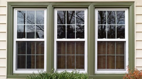 Three double-hung windows with green trim