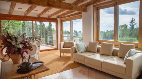 Upper living room view onto garden, pool and courtyard of Spanish farmhouse