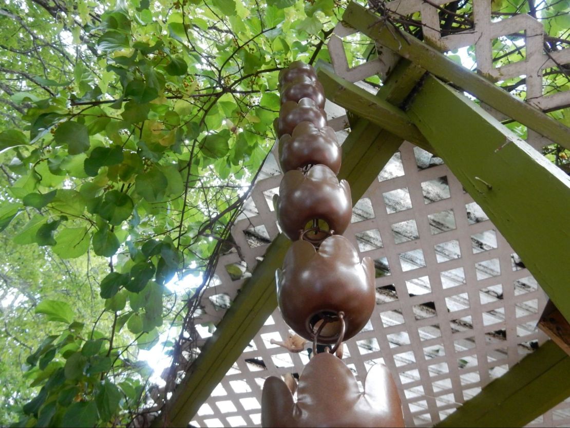 A rain chain made of small buckets.