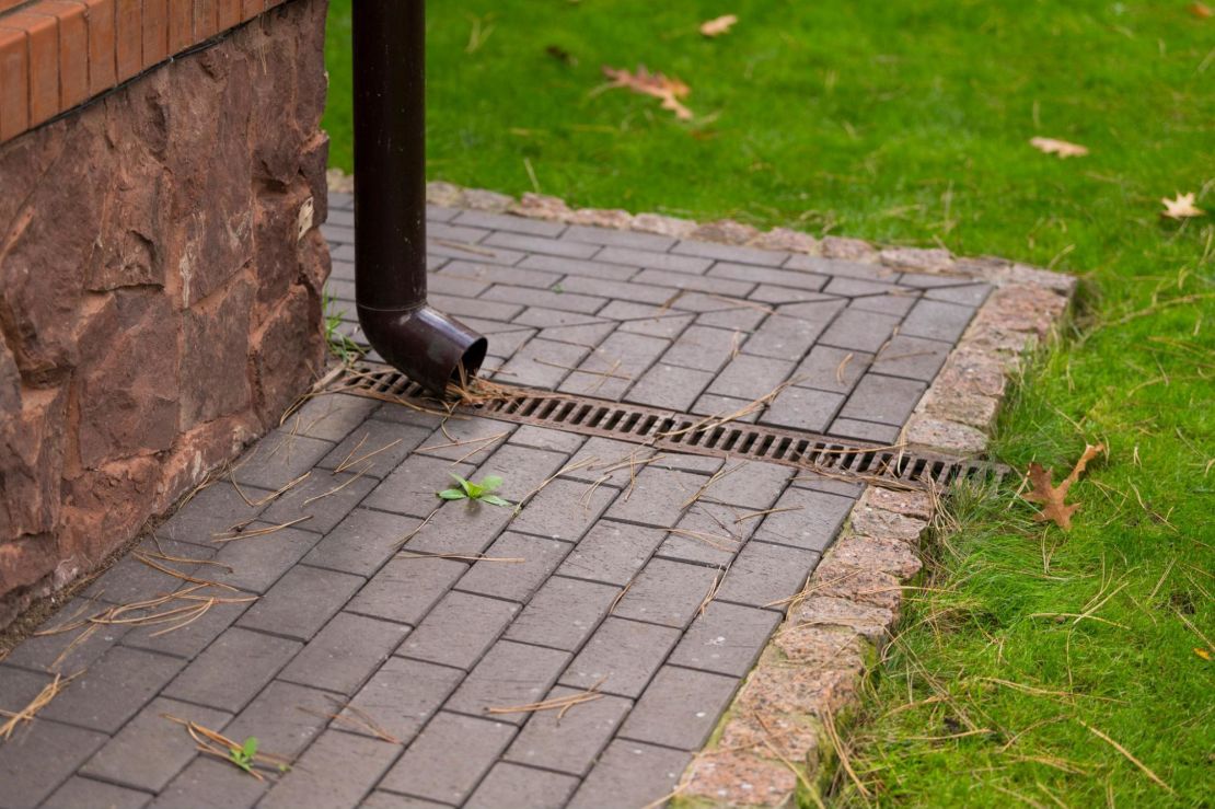 water drains into an underground rain gutter.