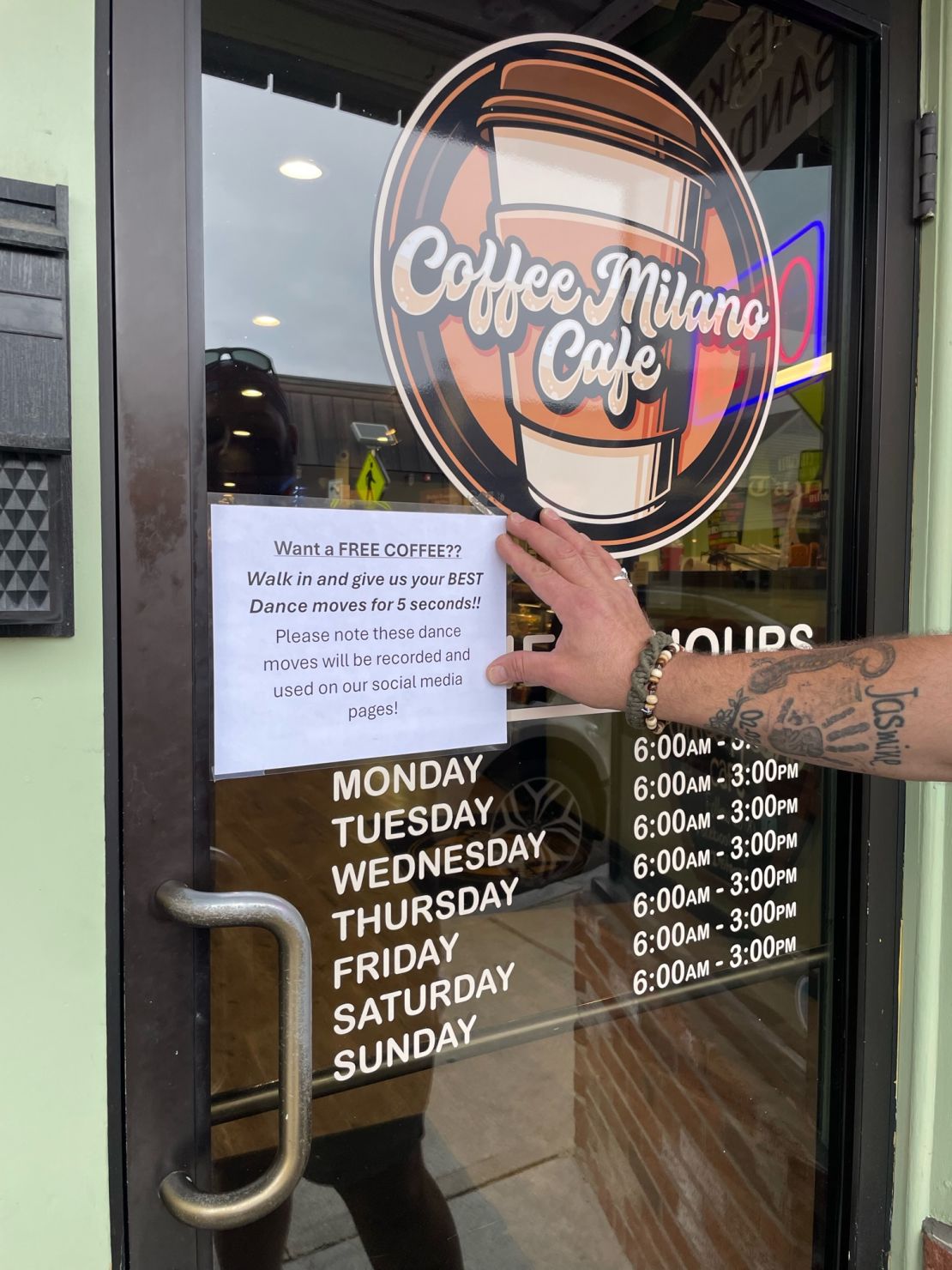 The sign posted outside of Coffee Milano Cafe informing customers of the promotion.