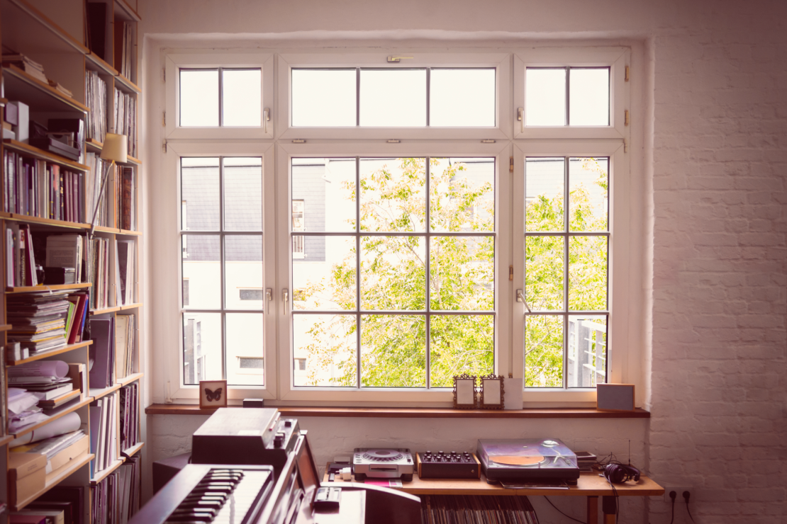 Large multi-panel casement window in a music room 