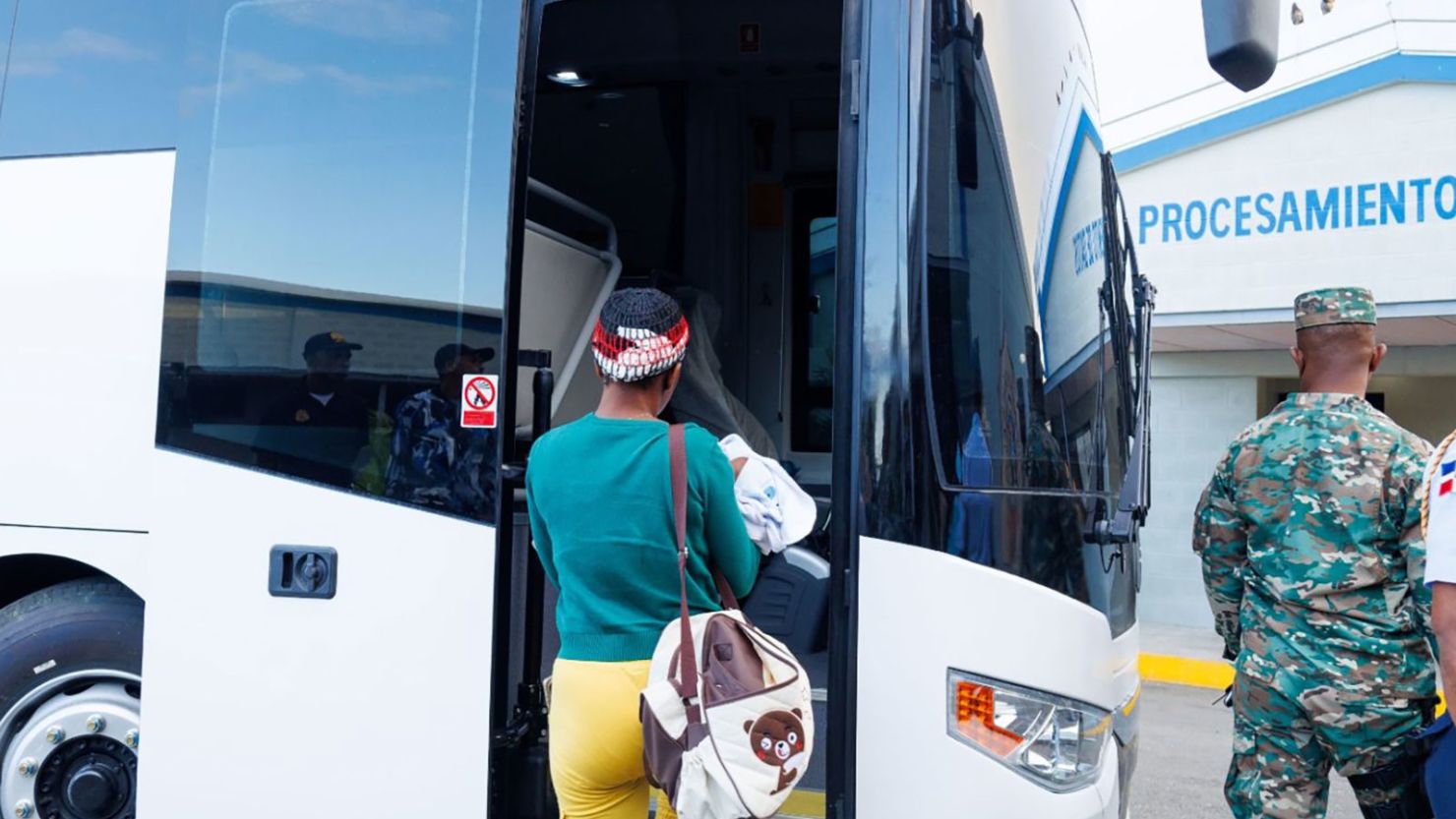 A woman being returned to Haiti boards a bus in the Dominican Republic.