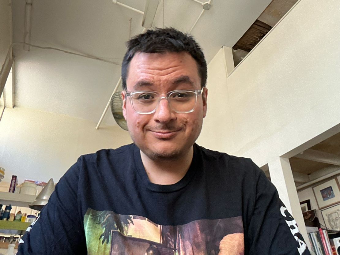 A selfie the author captured on the iPad Pro M4 where he's smiling in a room with a large ceiling.