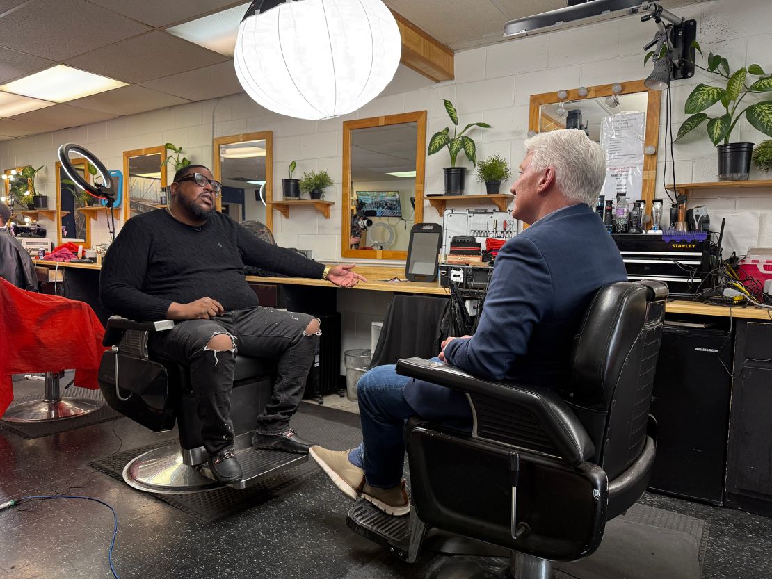 Eric Jones talks with John King at a barbershop in Milwaukee, Wisconsin.