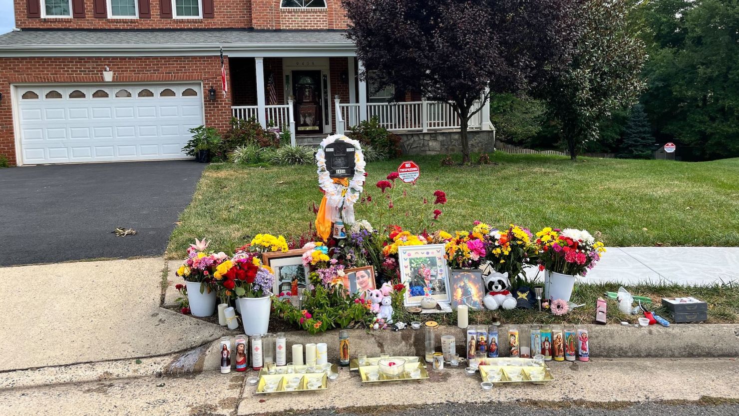 A makeshift memorial stands outside the Bhatt family home Thursday.
