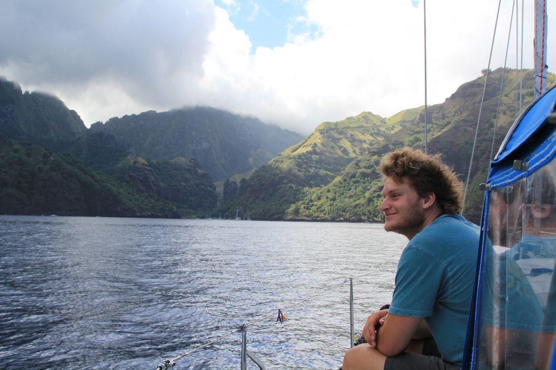 When they reached the Marquesas Islands, they celebrated with a bottle of Champagne and calls home to their families. They made landfall on the island of Fatu Hiva, seen here behind Ted Lewitt.