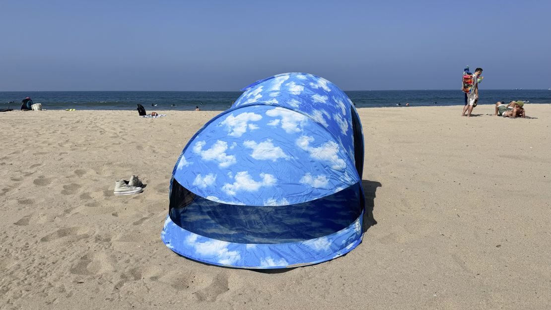 Back of Baggu Pop Up Tent on the beach, facing the ocean.