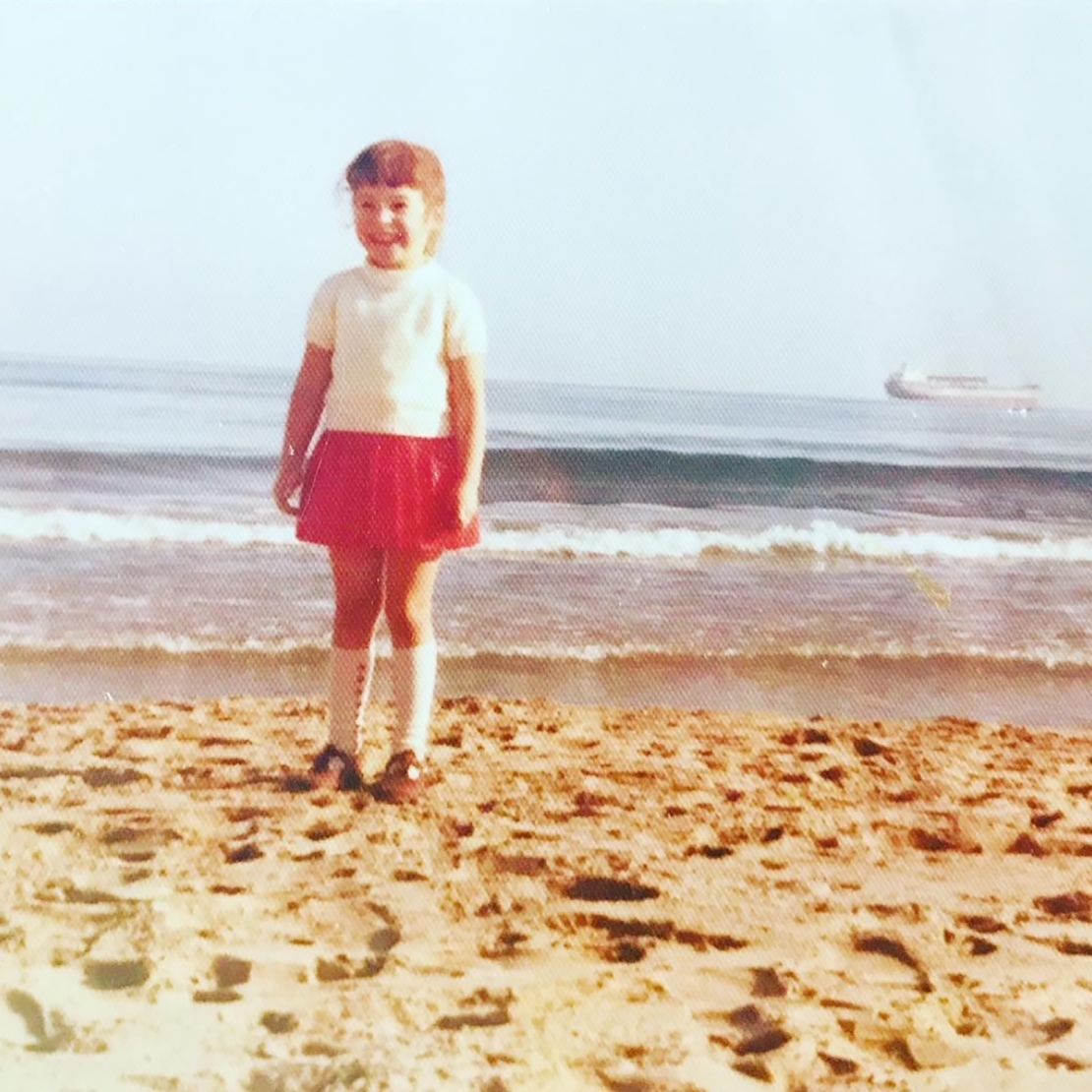 Maria pictured on the beach in the Spanish city aged five. 