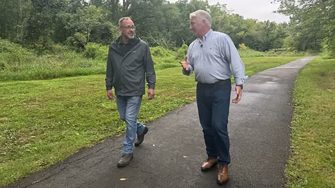 Pennsylvania voter Michael Pesce walks with John King in Bucks County.