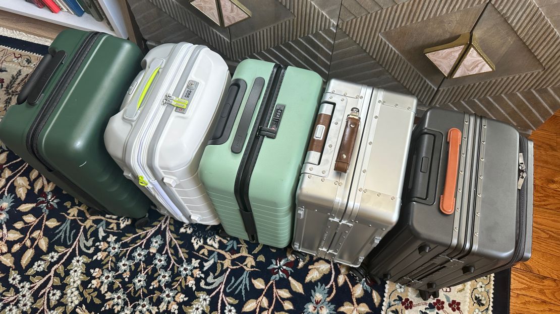 A photo of the top of five carry-on bags