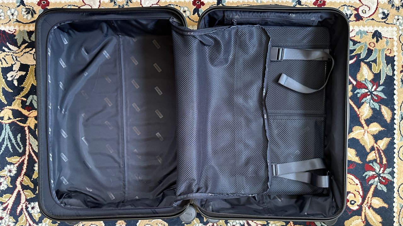 A photo of the Away Bigger Carry On's two interior compartments with an open zippered compartment