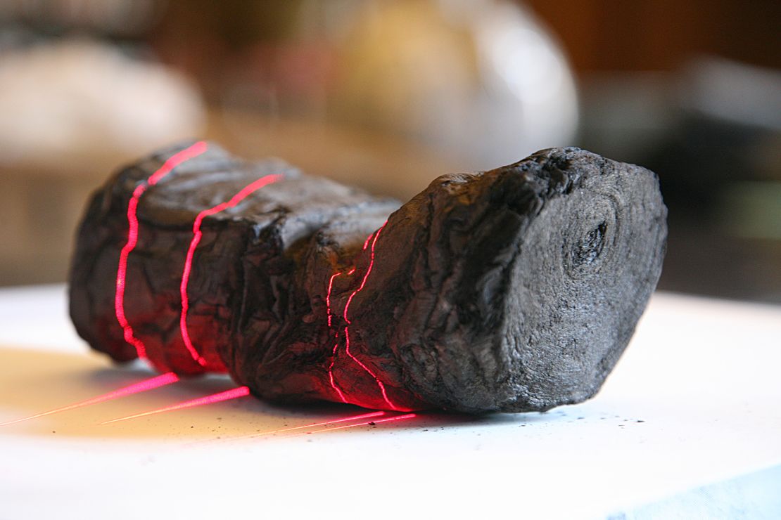 One of the Herculaneum scrolls undergoes analysis using lasers.