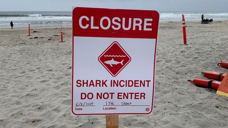 A sign announcing the closure of a stretch of beach in Del Mar after an apparent shark attack is seen on June 2, 2024.