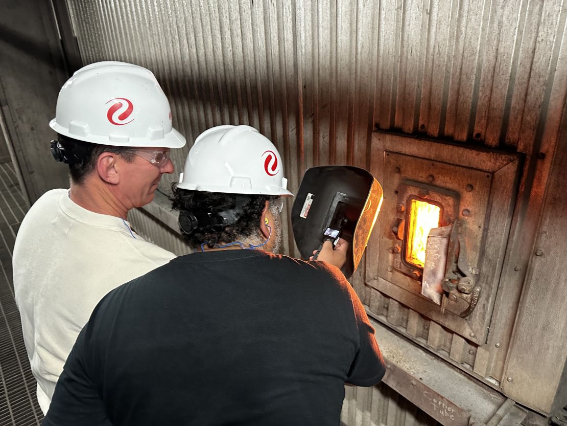 CNN's Bill Weir looks at the coal fire that generates energy for thousands of customers through a protective welder's mask.