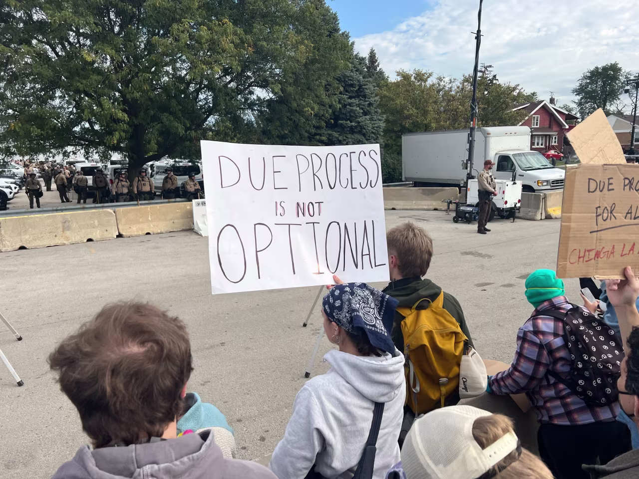 A woman held a sign that read, "Due process is not optional" during a protests near the Immigration and Customs Enforcement facility in Broadview, Illinois.